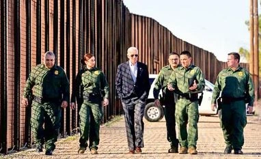 President Joe Biden visits US-Mexico border as immigration issue hots up US President Joe Biden with border patrol officers as he walks along the border fence during his visit to the US-Mexico border to assess border enforcement operations, in El Paso, Texas Photo:Reuters