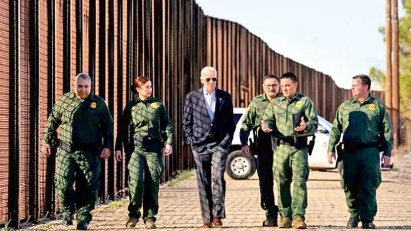 US President Joe Biden with border patrol officers as he walks along the border fence during his visit to the US-Mexico border to assess border enforcement operations, in El Paso, Texas Photo:Reuters US President Joe Biden with border patrol officers as he walks along the border fence during his visit to the US-Mexico border to assess border enforcement operations, in El Paso, Texas Photo:Reuters